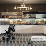 Grande cucina moderna con passeggino abbandonato e spesa lasciata per terra